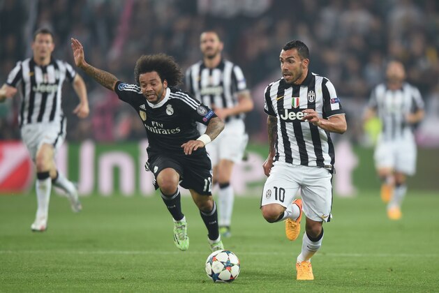 TURIN, ITALY - MAY 05:  Carlos Tevez of Juventus in action with Marcelo of Real Madrid during the UEFA Champions League semi final match between Juventus and Real Madrid at Juventus Arena on May 5, 2015 in Turin, Italy.  (Photo by Michael Regan/Getty Images)