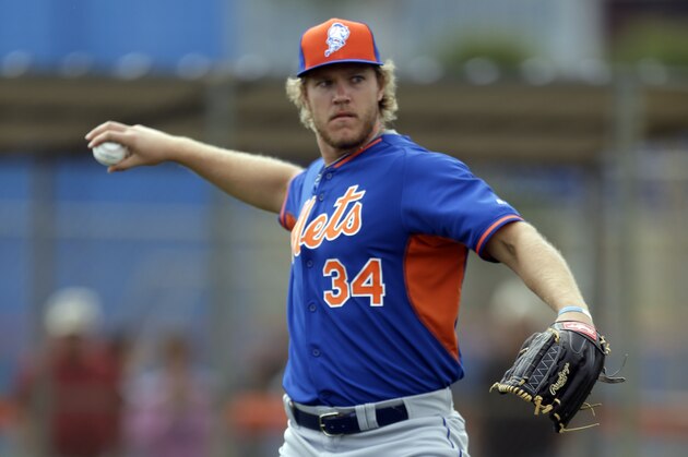 New York Mets pitcher Noah Syndergaard throws to first during spring training baseball practice Saturday, Feb. 21, 2015, in Port St. Lucie, Fla. (AP Photo/Jeff Roberson)