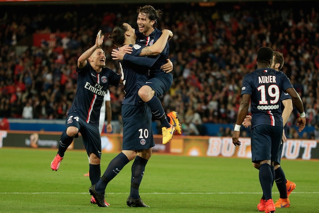 Paris Saint Germain's Maxwell, center, celebrates with teammates Paris Saint Germain's Zlatan Ibrahimovic and Marco Verratti after scoring a goal, during his League One soccer match against Guingamp, at the Parc des Princes stadium, in Paris, France, Friday, May 8, 2015. (AP Photo/Thibault Camus)