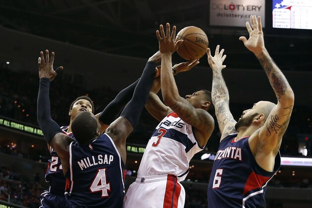 Washington Wizards guard Bradley Beal (3) tries to shoot between Atlanta Hawks' Kent Bazemore, left, Paul Millsap (4) and Pero Antic (6), from Macedonia, in the first half of Game 4 of the second round of the NBA basketball playoffs Monday, May 11, 2015, in Washington. (AP Photo/Alex Brandon)