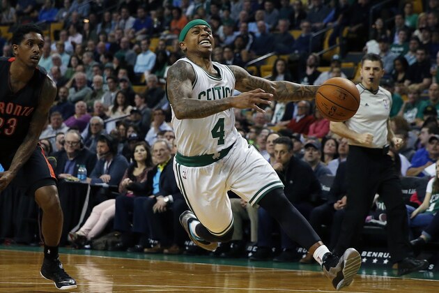 Boston Celtics' Isaiah Thomas (4) drives for the basket in front of Toronto Raptors' Louis Williams (23) during the first quarter of an NBA basketball game in Boston, Tuesday, April 14, 2015. (AP Photo/Michael Dwyer)