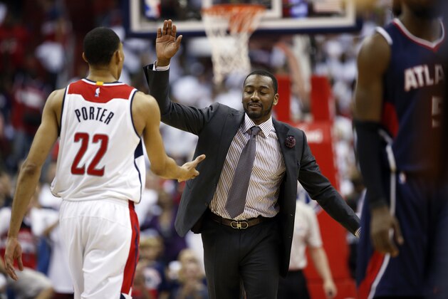 Washington Wizards guard John Wall, right, celebrates with Washington Wizards forward Otto Porter Jr. (22) during a break in the second half of Game 3 of the second round of the NBA basketball playoffs against the Atlanta Hawks, Saturday, May 9, 2015, in Washington. The Wizards won 103-101. (AP Photo/Alex Brandon)
