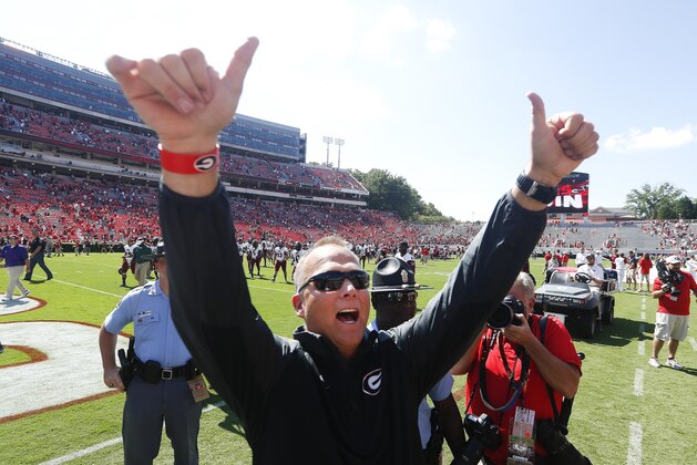 Georgia head coach Mark Richt gestures toward the crowd after defeating Troy 66-0 in an NCAA college football game, Saturday, Sept. 20, 2014, in Athens, Ga. (AP Photo/John Bazemore)