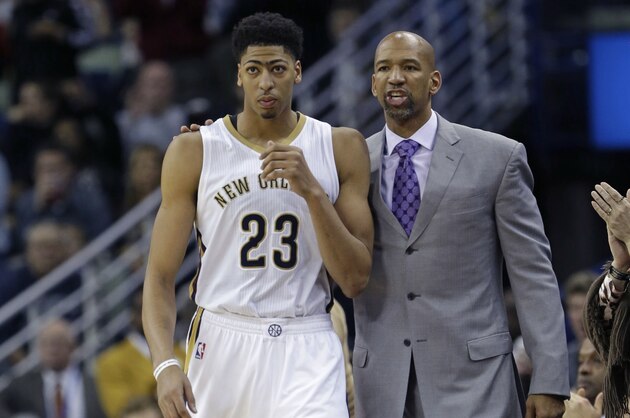 New Orleans Pelicans head coach Monty Williams walks with forward Anthony Davis (23) as Anthony returns to the game after leaving for a pulled groin in the second half of an NBA basketball game in New Orleans, Wednesday, Jan. 28, 2015. The Nuggets won 93-85. (AP Photo/Gerald Herbert)