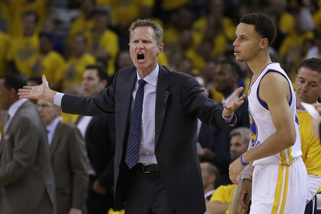 Golden State Warriors head coach Steve Kerr, left, reacts next to guard Stephen Curry during the first half of Game 2 in a second-round NBA playoff basketball series against the Memphis Grizzlies in Oakland, Calif., Tuesday, May 5, 2015. (AP Photo/Ben Margot)