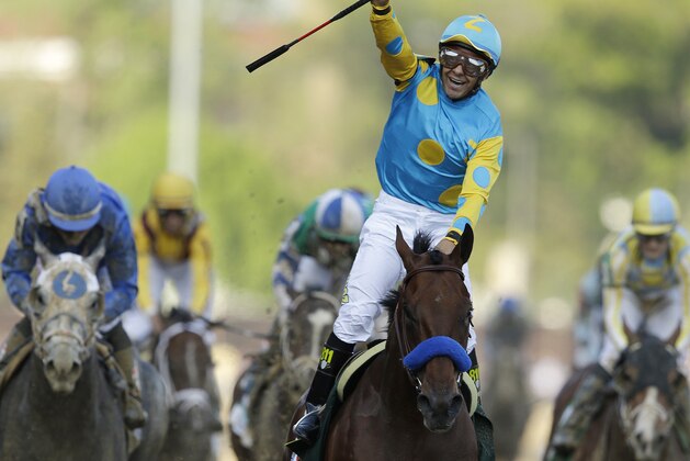 Victor Espinoza rides American Pharoah to victory in the 141st running of the Kentucky Derby horse race at Churchill Downs Saturday, May 2, 2015, in Louisville, Ky. (AP Photo/Darron Cummings)