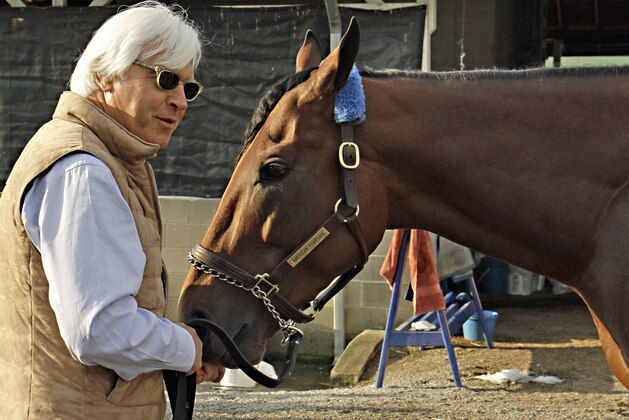 FILE - In this Sunday, May 3, 2015, file photo, Hall of Fame trainer Bob Baffert, left, feeds Kentucky Derby winner American Pharoah a carrot at Churchill Downs in Louisville, Ky., Sunday, May 3, 2015. Like almost every Kentucky Derby winner before him, American Pharoah is facing the inevitable question of whether he can win the Triple Crown. It hasn't been done since 1978, and with him and third-place Dortmund both trained by Baffert, it'll be interesting to see what happens at the Preakness. (AP Photo/Garry Jones, File)