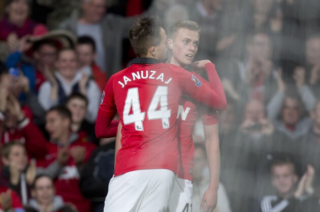 Manchester United's James Wilson, right, celebrates with teammate Adnan Januzaj after scoring his second goal against Hull during their English Premier League soccer match at Old Trafford Stadium, Manchester, England, Tuesday May 6, 2014. (AP Photo / Jon Super)