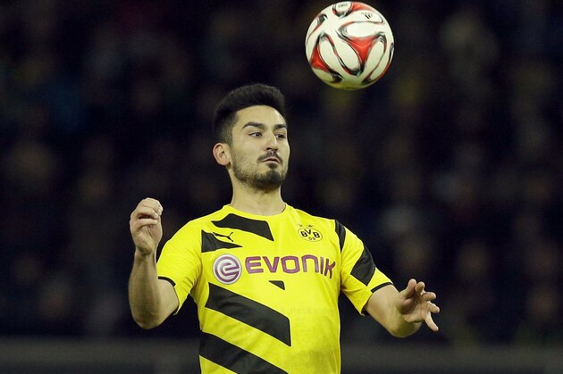 Dortmund's Ilkay Gundogan plays the ball during the German Bundesliga soccer match between Hertha BSC Berlin and Borussia Dortmund at the Olympia stadium in Berlin, Germany, Saturday, Dec. 13, 2014. Berlin defeated Dortmund by 1-0.(AP Photo/Michael Sohn)