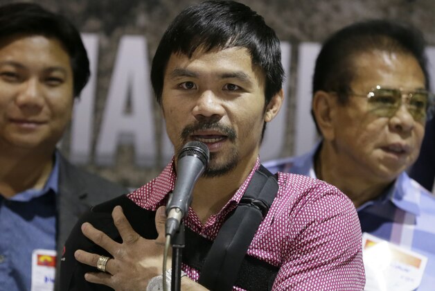Filipino boxer and Congressman Manny Pacquiao answers questions from the media during a news conference upon arrival Wednesday, May 13, 2015 at the Ninoy Aquino International Airport at suburban Pasay city south of Manila, Philippines. Pacquiao, who was defeated by Floyd Mayweather Jr. in their welterweight fight in Las Vegas May 2, faces lawsuits allegedly for not disclosing his shoulder injury before the fight. (AP Photo/Bullit Marquez)