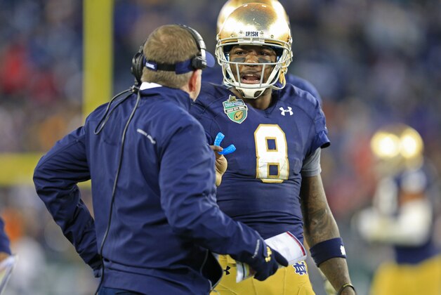 Notre Dame quarterback Malik Zaire (8) talks with coach Brian Kelly during the second half of the Music City Bowl NCAA college football game against LSU on Tuesday, Dec. 30, 2014, in Nashville, Tenn. Notre Dame beat LSU 31-28. (AP Photo/Mark Humphrey)