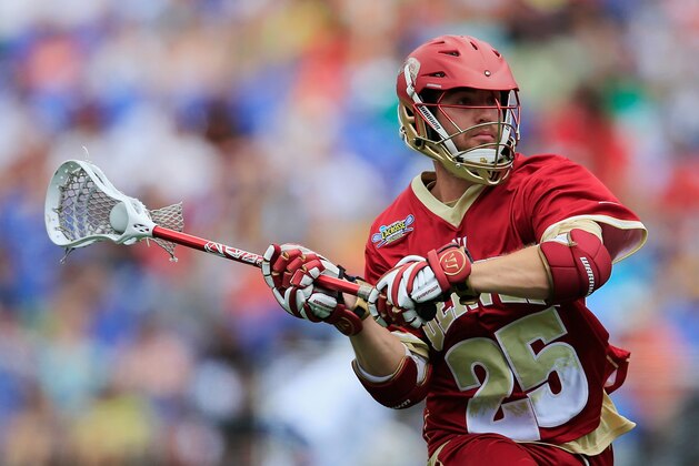 BALTIMORE, MD - MAY 24: Garret Holst #25 of the Denver Pioneers passes the ball against the Duke Blue Devils during the semifinals of the 2014 NCAA Division I Men's Lacrosse Championship at M&T Bank Stadium on May 24, 2014 in Baltimore, Maryland.  (Photo by Rob Carr/Getty Images)