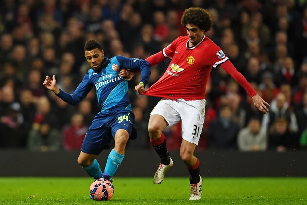MANCHESTER, ENGLAND - MARCH 09:  Francis Coquelin of Arsenal is challenged by Marouane Fellaini of Manchester United during the FA Cup Quarter Final match between Manchester United and Arsenal at Old Trafford on March 9, 2015 in Manchester, England.  (Photo by Laurence Griffiths/Getty Images)