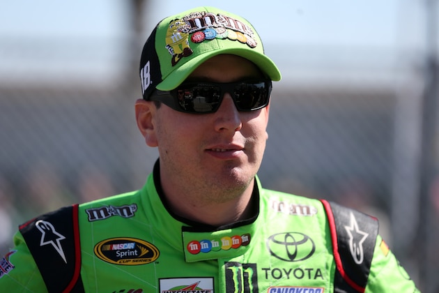 DAYTONA BEACH, FL - FEBRUARY 15:  Kyle Busch, driver of the #18 M&M's Crispy Toyota, stands on the grid during qualifying for the 57th Annual Daytona 500 at Daytona International Speedway on February 15, 2015 in Daytona Beach, Florida.  (Photo by Sarah Glenn/Getty Images)