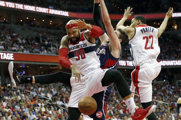 Washington Wizards forward Drew Gooden (90), Atlanta Hawks forward Mike Muscala and Wizards' Otto Porter Jr. (22) collide under the basket in the second half of Game 4 of the second round of the NBA basketball playoffs Monday, May 11, 2015, in Washington. The Hawks won 106-101. (AP Photo/Alex Brandon)