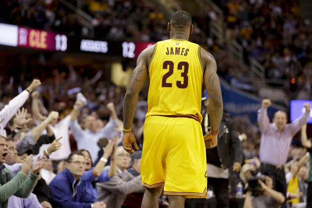 Spectators cheer Cleveland Cavaliers forward LeBron James (23) after James scored against the Chicago Bulls during the second half of Game 5 in a second-round NBA basketball playoff series Tuesday, May 12, 2015, in Cleveland. (AP Photo/Tony Dejak)