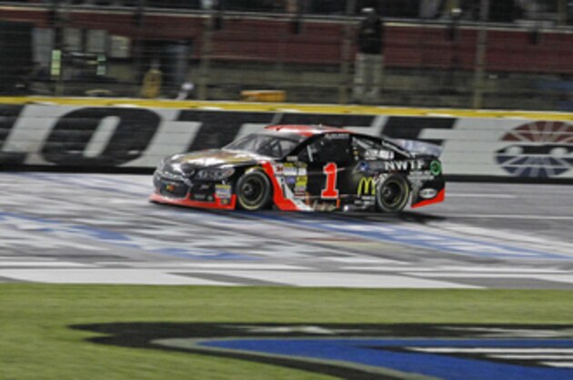 Jamie McMurray takes the checkered flag to win the NASCAR Sprint All-Star auto race at Charlotte Motor Speedway in Concord, N.C., Saturday, May 17, 2014. (AP Photo/Terry Renna)