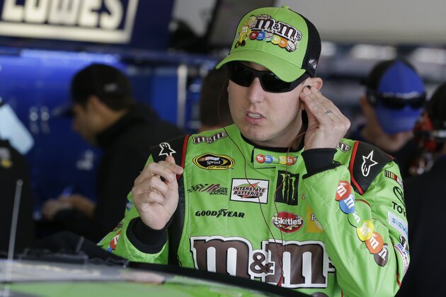 Kyle Busch prepares himself before getting in his car during a practice session for the Daytona 500 NASCAR Sprint Cup Series auto race at Daytona International Speedway, Saturday, Feb. 14, 2015, in Daytona Beach, Fla. (AP Photo/John Raoux)