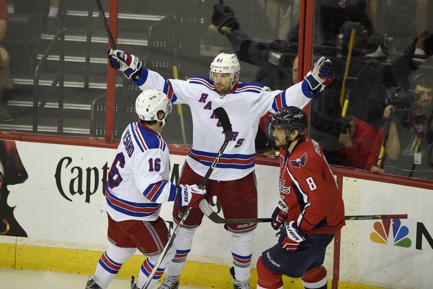 New York Rangers left wing Rick Nash (61) celebrates his goal with Derick Brassard (16) as Washington Capitals left wing Alex Ovechkin (8), from Russia, skates by during the third period of Game 6 in the second round of the NHL Stanley Cup hockey playoffs, Sunday, May 10, 2015, in Washington. The Rangers won 4-3. (AP Photo/Nick Wass)