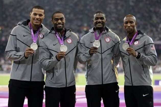 USA's Trell Kimmons, Justin Gatlin, Tyson Gay and Ryan Bailey celebrate after receiving their silver medals for the men's 4x100-meter during the athletics in the Olympic Stadium at the 2012 Summer Olympics, London, Saturday, Aug. 11, 2012. (AP Photo/Matt Slocum)