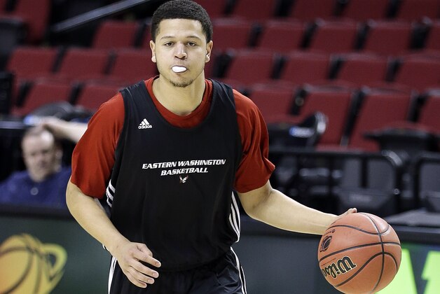 Eastern Washington guard Tyler Harvey blows a gum bubble while dribbling during practice for an NCAA college basketball second-round game in Portland, Ore., Wednesday, March 18, 2015. Eastern Washington is to play Georgetown on Thursday. (AP Photo/Don Ryan)