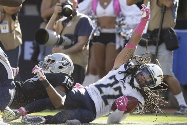 ADVANCE FOR WEEKEND EDITIONS, NOV. 1-2 - FILE - In this Oct. 12, 2014, file photo, San Diego Chargers cornerback Jason Verrett (22) celebrates after intercepting a pass intended for Oakland Raiders wide receiver Brice Butler, left, during the fourth quarter of an NFL football game in Oakland, Calif. Rookies, especially those selected high in the draft, not only are given a chance to prove themselves but are expected to contribute immediately. (AP Photo/Ben Margot, File)