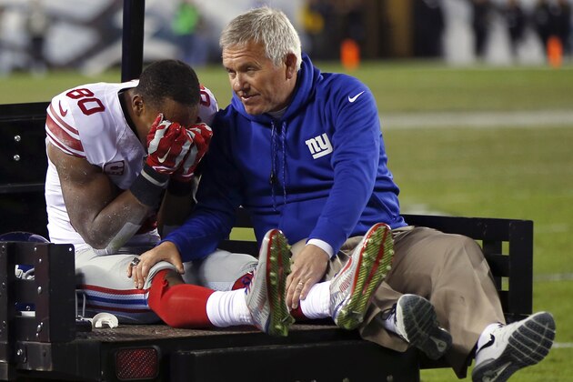 FILE - In this Oct. 12, 2014, file photo, New York Giants wide receiver Victor Cruz, left, is carted off the field during the second half of an NFL football game against the Philadelphia Eagles in Philadelphia. Cruz had one of the season's more heartbreaking moments, sobbing into his hands after tearing his patellar tendon  (AP Photo/Matt Rourke, File)