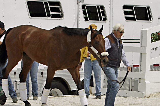 Hall of Fame trainer Bob Baffert leads Kentucky Derby winner American Pharoah off the van at Pimlico Race Course in Baltimore, Wednesday, May 13, 2015.  The Preakness Stakes horse race is Saturday, May 16.(AP Photo/Garry Jones)