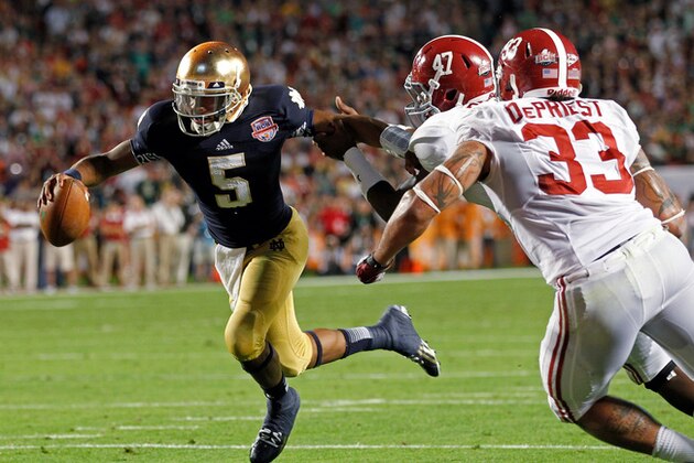 Notre Dame quarterback Everett Golson (5) runs past Alabama's Xzavier Dickson (47) and Trey DePriest (33) for a touchdown during the second half of the BCS National Championship college football game Monday, Jan. 7, 2013, in Miami. (AP Photo/Wilfredo Lee)