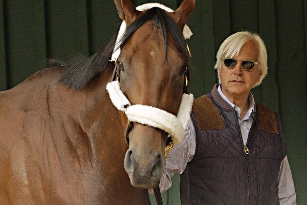 Trainer Bob Baffert walks Kentucky Derby winner American Pharoah in the stakes barn at Pimlico Race Course in Baltimore, Wednesday, May 13, 2015 after the colt's arrival from Louisville for the May 16th Preakness Stakes.  (AP Photo/Garry Jones)