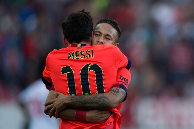 SEVILLE, SPAIN - APRIL 11:  Lionel Messi (L) of FC Barcelona celebrates scoring their opening goal with teammate Neymar JR. (R) during the La Liga match between Sevilla FC and FC Barcelona at Estadio Ramon Sanchez Pizjuan on April 11, 2015 in Seville, Spain.  (Photo by Gonzalo Arroyo Moreno/Getty Images)