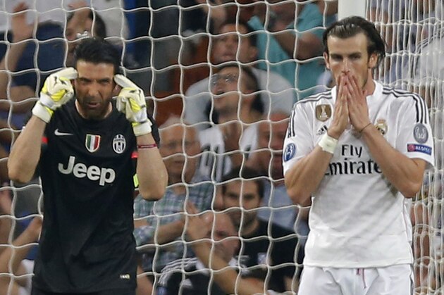Juventus goalkeeper Gianluigi Buffon gestures as Real Madrid's Gareth Bale holds his face after heading the ball over the goal during the Champions League second leg semifinal soccer match between Real Madrid and Juventus, at the Santiago Bernabeu stadium in Madrid, Wednesday, May 13, 2015. The match ended in a 1-1 draw, Juventus won on aggregate and will play Barcelona in the Champions League final on June 6, 2015 in Berlin. (AP Photo/Daniel Ochoa de Olza)