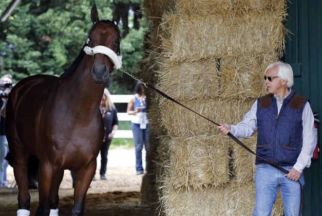 May 13, 2015; Baltimore, MD, USA; (editors note: caption correction) Horse trainer Bob Baffert walks American Pharoah inside the Preakness Barn after arriving for the 140th Preakness Stakes at Pimlico Race Course. Mandatory Credit: Geoff Burke-USA TODAY Sports