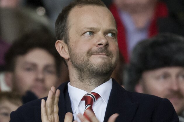 Manchester United chief executive Ed Woodward applauds before the team's English Premier League soccer match against Tottenham at Old Trafford Stadium, Manchester, England, Wednesday Jan. 1, 2014. (AP Photo/Jon Super)