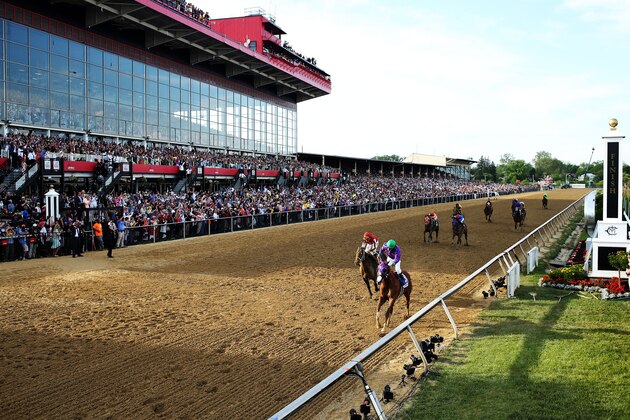 BALTIMORE, MD - MAY 17:  California Chrome #3, ridden by Victor Espinoza, races accross the finishline to win the 139th running of the Preakness Stakes at Pimlico Race Course on May 17, 2014 in Baltimore, Maryland.  (Photo by Matthew Stockman/Getty Images)