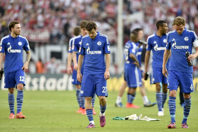 Schalke's Marco Hoeger, left, Tranquillo Barnetta, center, and Benedikt Hoewedes leave the pitch disappointed after losing the German Bundesliga soccer match between 1. FC Cologne and FC Schalke 04 in Cologne, Germany, Sunday, May 10, 2015.  Cologne defeated Schalke with 1-0. (AP Photo/Martin Meissner)
