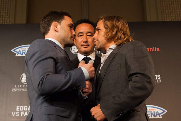 MANILA, PHILIPPINES - MARCH 10:  UFC Asia executive vice president Kenneth Berger stand in the middle of featherweights Frankie Edgar and Uriah Faber during their face off at the UFC Manila Press Conference on March 10, 2015 in Manila, Philippines.  (Photo by Dondi Tawatao/Getty Images)