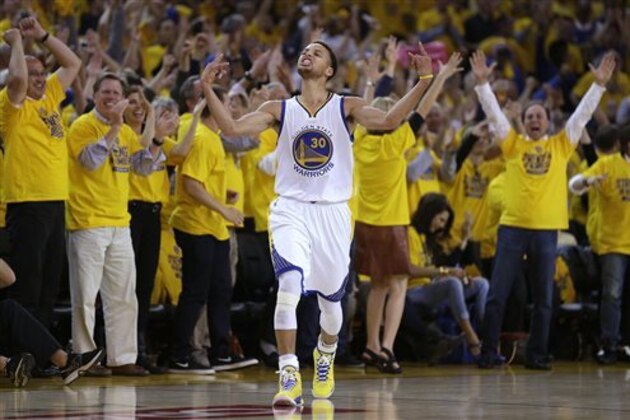 Fans cheer as Golden State Warriors guard Stephen Curry (30) reacts after scoring during the first half of Game 5 in a second-round NBA playoff basketball series against the Memphis Grizzlies in Oakland, Calif., Wednesday, May 13, 2015. (AP Photo/Ben Margot)