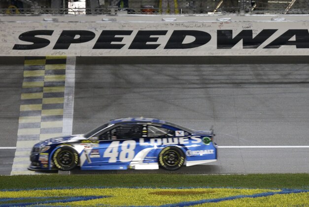 NASCAR driver Jimmie Johnson (48) crosses the finish line to win the NASCAR Sprint Cup series auto race at Kansas Speedway in Kansas City, Kan., Saturday, May 9, 2015. (AP Photo/Orlin Wagner)