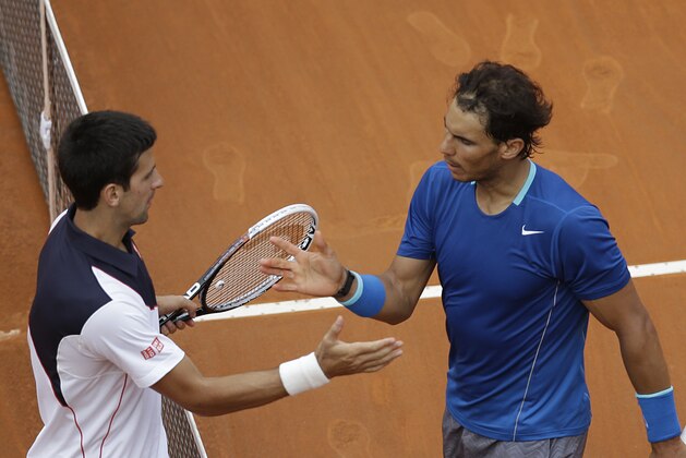 Serbia's Novak Djokovic, left, congratulates Spain's Rafael Nadal after winning the final match at the Italian open tennis tournament in Rome, Sunday, May 18, 2014. Novak Djokovic extended his recent dominance over Rafael Nadal by rallying for a 4-6, 6-3, 6-3 victory Sunday to win the Italian Open for the third time. (AP Photo/Gregorio Borgia)