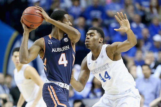NASHVILLE, TN - MARCH 14: Dakari Johnson #44 of the Kentucky Wildcats defends Trayvon Reed #4 of the Auburn Tigers during the SEC Basketball Tournament Semifinals at Bridgestone Arena on March 14, 2015 in Nashville, Tennessee.  (Photo by Andy Lyons/Getty Images)