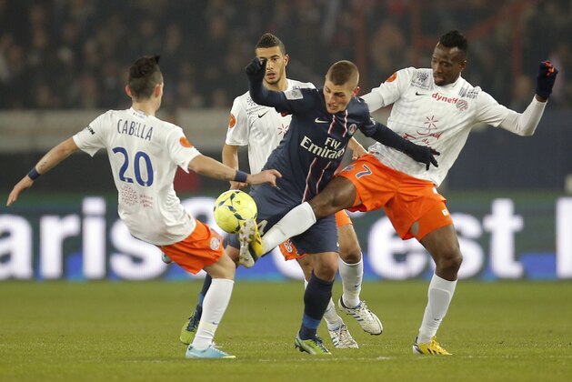 Paris Saint Germain's Marco Verratti , center, vies for the ball with Montpellier's Remy Cabella, left and John Chukwudi Utaka, right, during their League One soccer match between PSG and Montpellier at Parc des Princes Stadium, in Paris, Friday March 29, 2013. (AP Photo/Francois Mori)