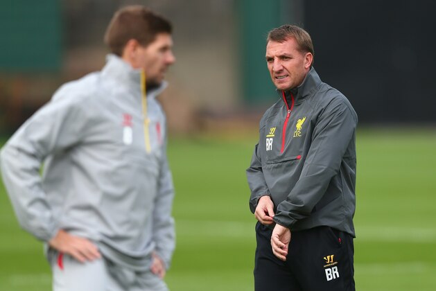 LIVERPOOL, ENGLAND - SEPTEMBER 15:  Liverpool manager Brendan Rodgers about to check his watch as he walks past Liverpool captain Steven Gerrard during a training session ahead of their UEFA Champions League group B match against PFC Ludogorets on September 15, 2014 in Liverpool, United Kingdom.  (Photo by Clive Brunskill/Getty Images)