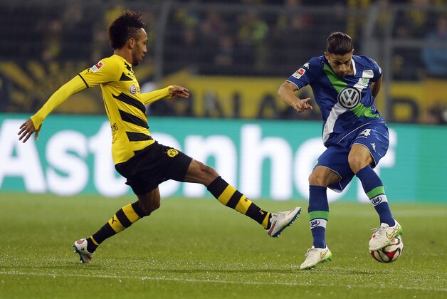 Dortmund's Pierre-Emerick Aubameyang, left, and Wolfburg's Ricardo Rodriguez challenge for the ball during the German first division Bundesliga soccer match between Borussia Dortmund and VfL Wolfsburg in Dortmund, Germany, Wednesday, Dec. 17, 2014. (AP Photo/Frank Augstein)