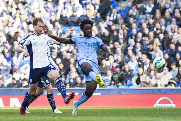 Manchester City's Wilfried Bony, right, scores against West Bromwich Albion during the English Premier League soccer match between Manchester City and West Bromwich Albion at the Etihad Stadium, Manchester, England, Saturday March 21, 2015. (AP Photo/Jon Super)