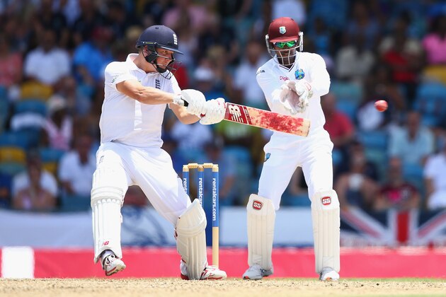 BRIDGETOWN, BARBADOS - MAY 01: Gary Ballance  of England cuts a delivery off the bowling of Marlon Samuels of West Indies as wicketkeeper Denesh Ramdin looks on during day one of the 3rd Test match between West Indies and England at Kensington Oval on May 1, 2015 in Bridgetown, Barbados.  (Photo by Michael Steele/Getty Images)