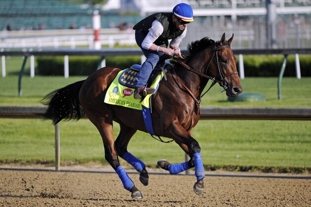 Apr 29, 2015; Louisville, KY, USA; Exercise rider Jorge Alvarez works out Kentucky Derby hopeful American Pharoah trained by Bob Baffert at Churchill Downs. Mandatory Credit: Jamie Rhodes-USA TODAY Sports