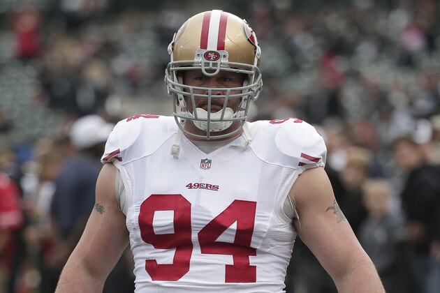 San Francisco 49ers defensive tackle Justin Smith (94) warms up before an NFL football game against the Oakland Raiders in Oakland, Calif., Sunday, Dec. 7, 2014. (AP Photo/Marcio Jose Sanchez)