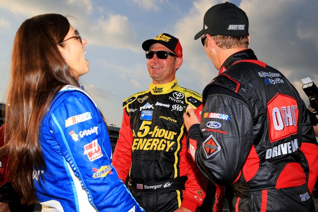 CHARLOTTE, NC - MAY 15:  (L-R) Danica Patrick, driver of the #10 Mobil 1/Aspen Dental Chevrolet, Clint Bowyer, driver of the #15 Cherry 5-Hour Energy/Special Operations Warrior Foundation Toyota, and Greg Biffle, driver of the #16 Ortho Ford, talk on the grid prior to the NASCAR Sprint Cup Series Sprint Showdown at Charlotte Motor Speedway on May 15, 2015 in Charlotte, North Carolina.  (Photo by Daniel Shirey/Getty Images)
