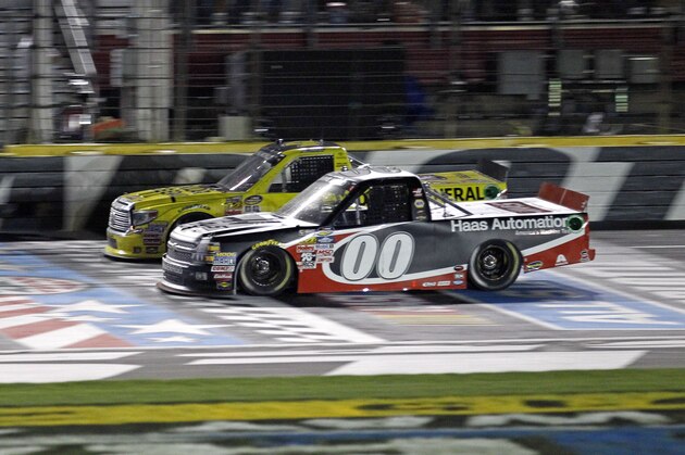 Kasey Kahne (00) leads Erik Jones across the start-finish line to win the NASCAR Trucks series Education Lottery auto race at Charlotte Motor Speedway in Concord, N.C., Friday, May 15, 2015. (AP Photo/Terry Renna)
